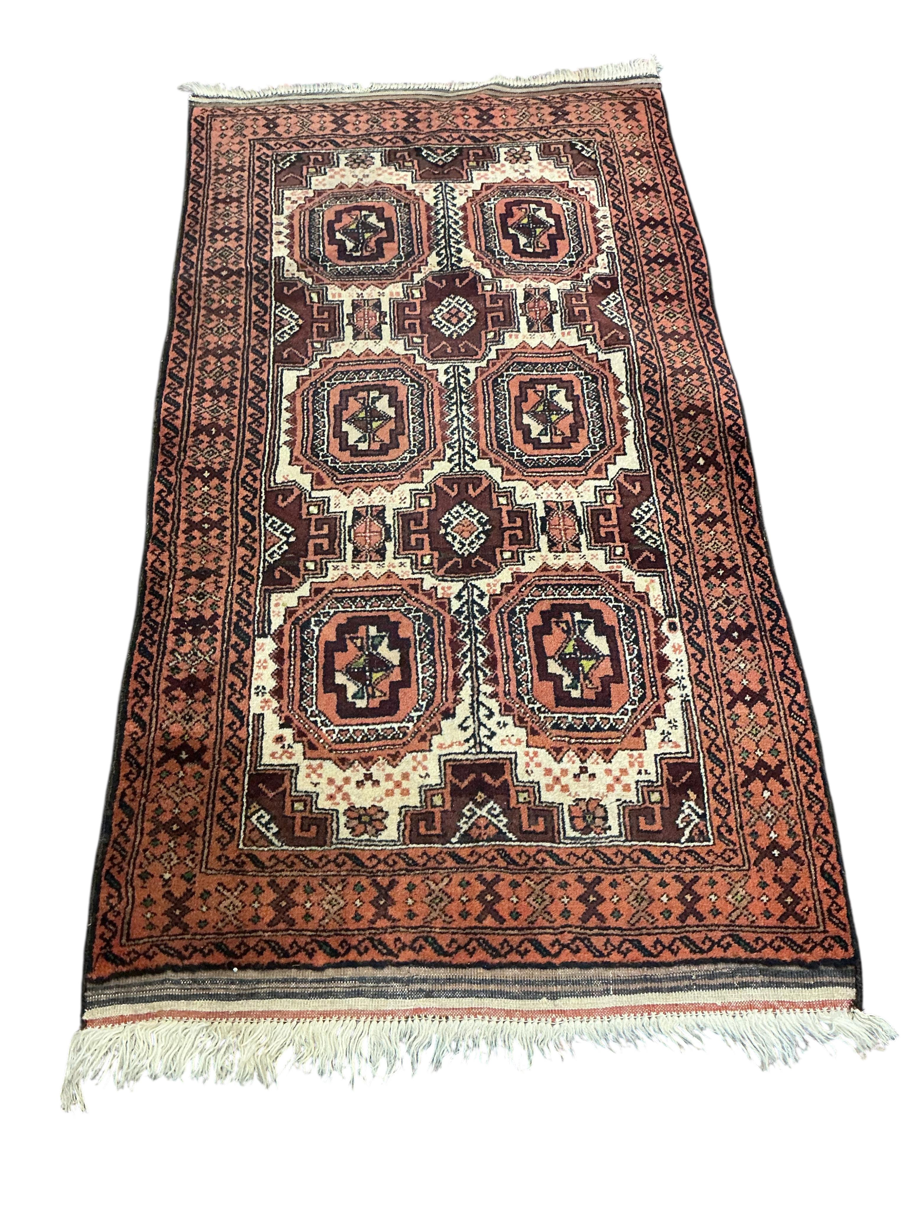 A Bokhara red ground runner and smaller rug, larger 300 x 78cm